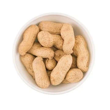 Round ceramic bowl of peanuts in shells. Top view. Stock Photos
