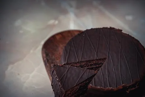 Round chocolate cake with triangular slice cut off Stock Photos