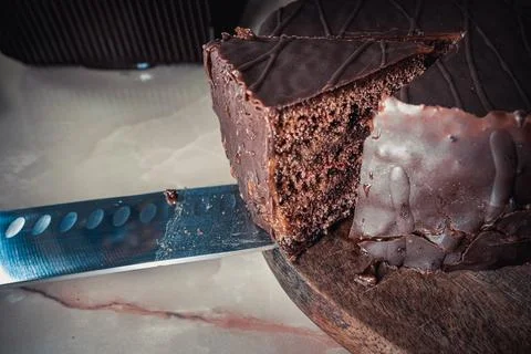 Round chocolate cake with triangular slice cut off Stockfoto's