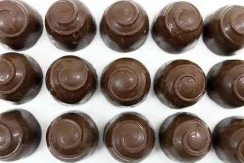 Round chocolate candy isolated on white background. Stock Photos