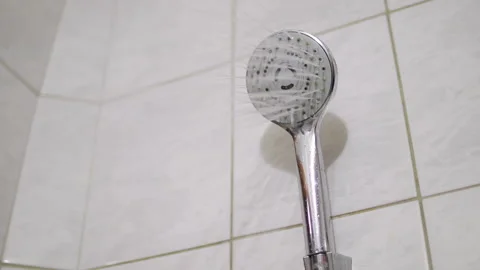 Round clean shower head at bathroom interior, close-up. Turning on and off Stock Footage 219547288