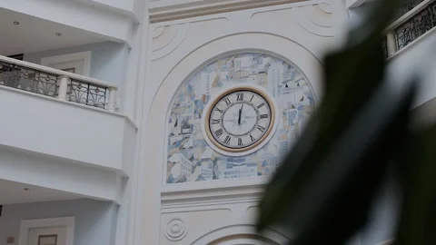 Round clock face with Roman numerals on the wall indoors Vídeos de archivo 144419927