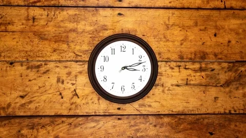 A round clock mounted to the side. Timelapse 4k Video stock 136520684