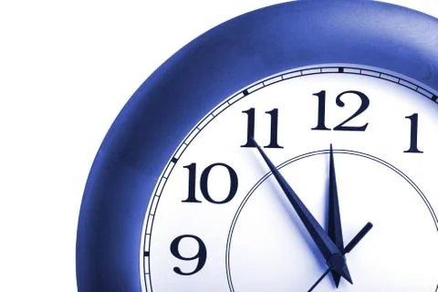 Round clock showing time about twelve isolated Stock Photos