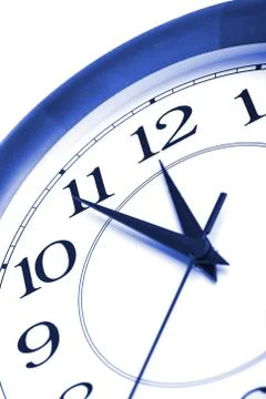 Round clock showing time about twelve isolated Stock Photos