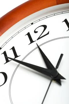 Round clock showing time about twelve isolated Stock Photos