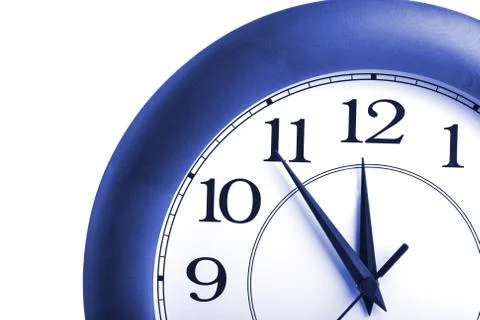 Round clock showing time about twelve isolated Stock Photos