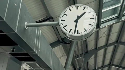 Round clock at a train station showing the time Video stock 278316004