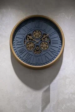A round clock on the wall indicates the exact time. decor in the room Stock Photos