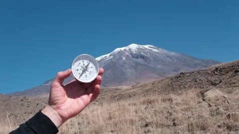 Round compass in hand on the background of Mount Ararat. Stock Footage 316385830