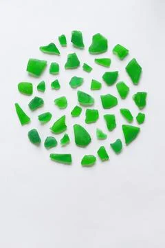 Round composition of various green assorted polished pieces of glass on a whi Stock Photos