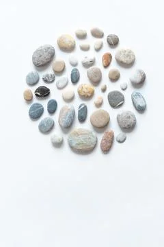 Round composition of various pebbles on a white background. Minimalistic natu Stock Photos