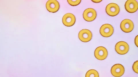 Round cookies biscuit making pattern on light purple theme. Stop motion Stock Footage 169302439