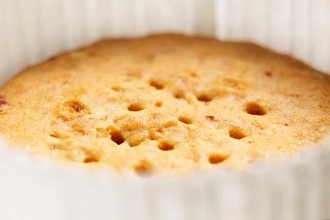 Round cookies with a hole pattern and red cranberry pieces in paper packaging Stock Photos