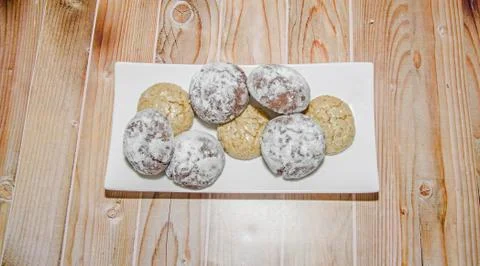 Round cookies stack on a white plate, powder sugar, wood background Stock Photos