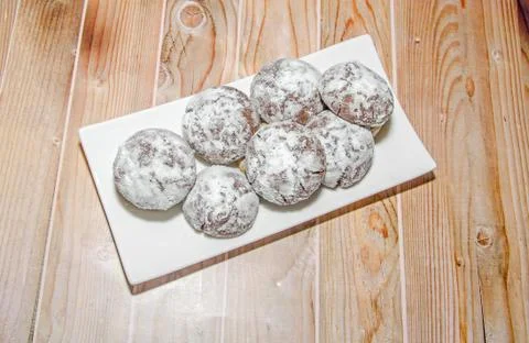 Round cookies stack on a white plate, powder sugar, wood background Stock Photos