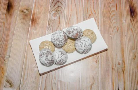Round cookies stack on a white plate, powder sugar, wood background Stock Photos
