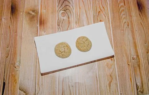 Round cookies stack on a white plate, powder sugar, wood background Stock Photos