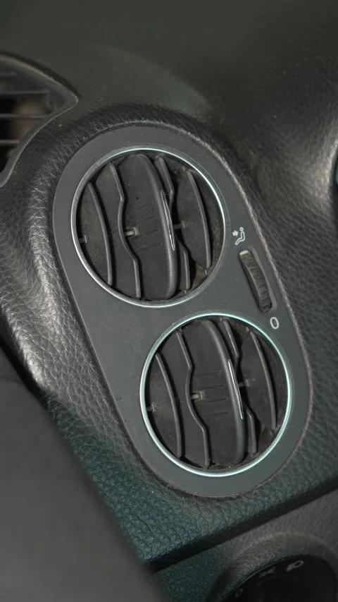 A round dashboard air vent assembly is installed in a car. Stock Footage 341333568