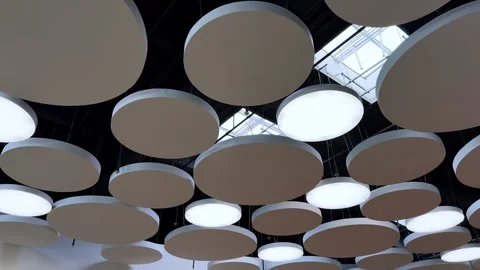 Round decorative elements of diverse size hanging on the ceiling of the room Stock Footage 312807713