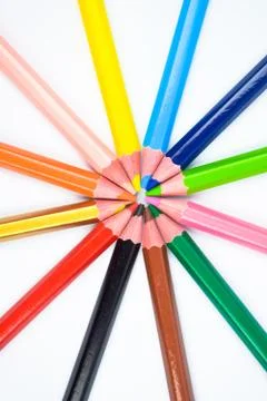 A round design made with some different colored wood pencil crayons on white Stock Photos