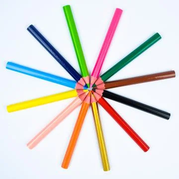 Round design made with some different colored wood pencil crayons on white ba Stock Photos