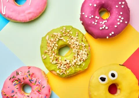 Round different donuts with sprinkles Stock Photos