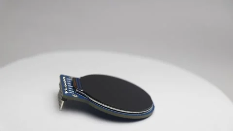 Round display module lying flat rotating slowly on white background Stock Footage 345885243