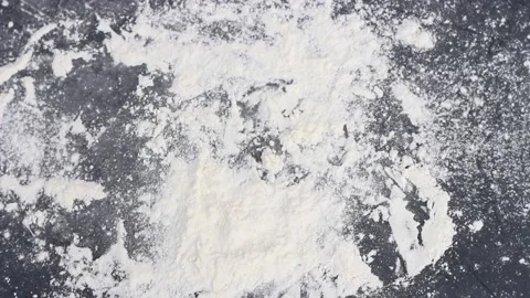 Round dough falls on gray table in flour. Stock Footage 123032687
