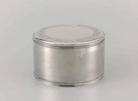 . Round drum of smooth silver with hinged lid. Signature and dated. Copyri... Stock Photos