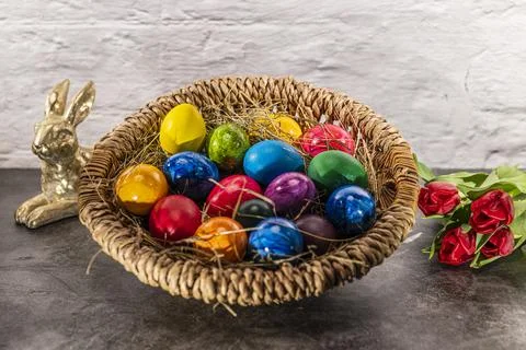 Round easter basket with colorful easter eggs and bunny Stock Photos