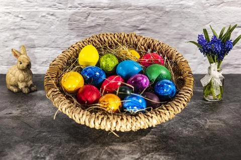 Round easter basket with colorful easter eggs and bunny Stock Photos