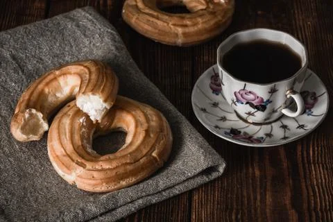 Round eclairs with cup of coffee Stock Photos