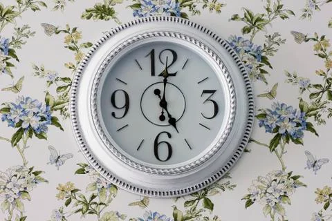 Round elegant white wall clock, five o'clock in the evening, interior details Stock Photos