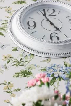 Round elegant white wall clock, five o'clock in the evening, interior details Stock Photos