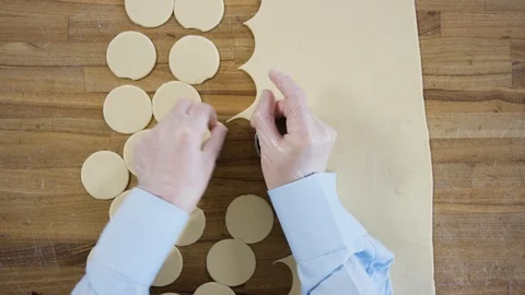 Round flat bread dough for dumplings. Scene. Top view close up of hands making Video stock 97598545