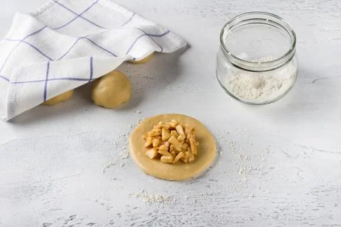 A round flat piece of rolled out dough stuffed with apples and cinnamon on .. Stock Photos