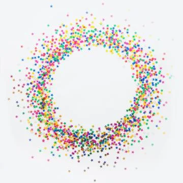 Round frame made of colored confetti stars. White background. Festive confetti. Stock Photos