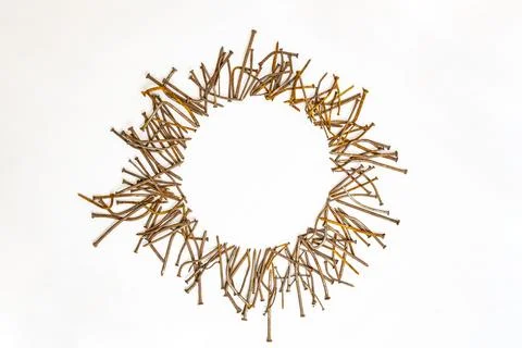 Round frame made of rusty bent nails on white background Stock Photos