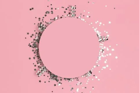 Round frame made of silver colored confetti. Stock Photos