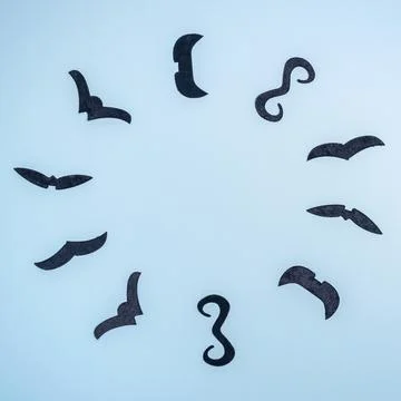 Round frame made with stylish black fake mustaches on blue Stock Photos