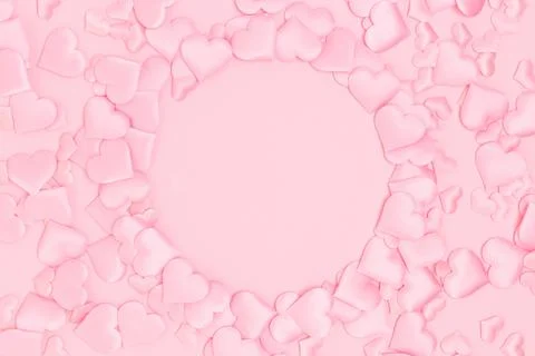 Round frame made of textile pink confetti in a heart shape. Stock Photos