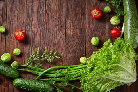The round frame made of vegetables and herbs on a wooden background, copy space Stock Photos