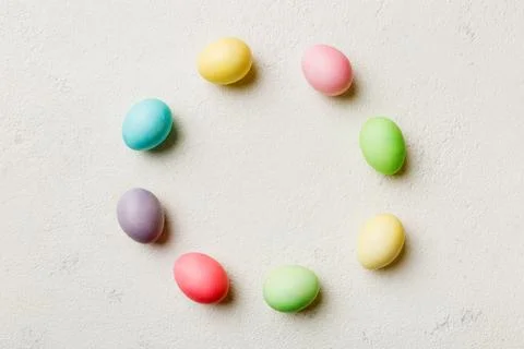 Round frame Multi colors Easter eggs on colored background . Pastel color Eas Stock Photos