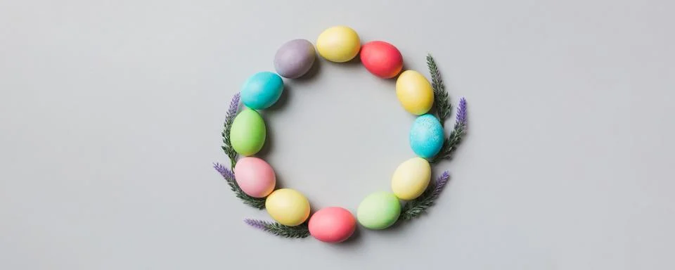 Round frame Multi colors Easter eggs on colored background . Pastel color E.. Stock Photos