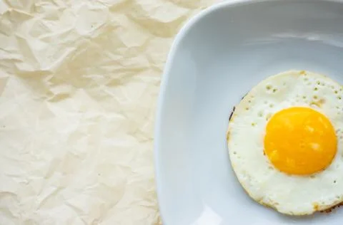 Round fried egg in the plate. Stock Photos