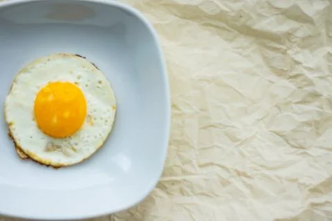 Round fried egg in the plate. Stock Photos