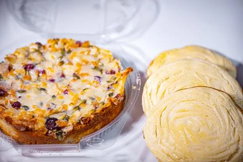 A round fruit and nut cake with cranberries, apricots and seeds. Stock Photos