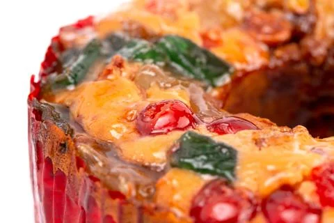 Round Fruit Cake with Cherries Pineapples and Nuts on a White Background Foto stock