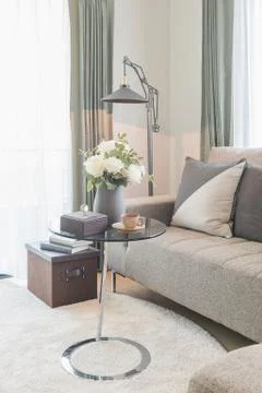 Round glass table with set of sofa in modern living room Stock Photos